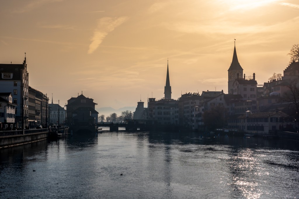 Sunset over the river and historic buildings in Zurich, Switzerland.